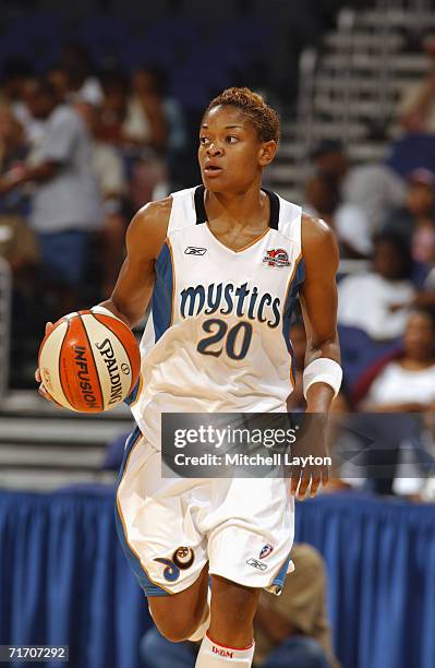 Alana Beard of the Washington Mystics moves the ball up court during a game against the Detroit Shock at MCI Center on August 11, 2006 in Washington,...
