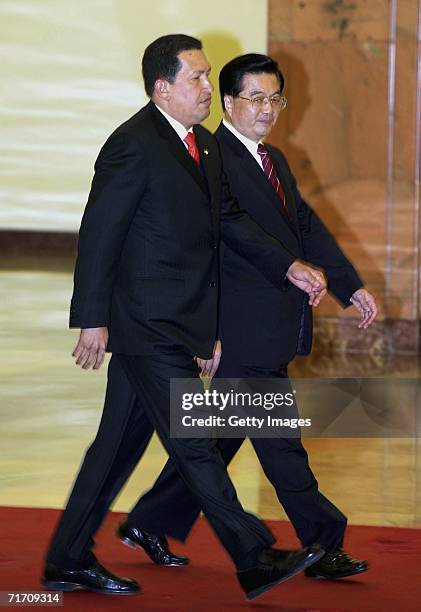 Venezuelan President Hugo Chavez and Chinese President Hu Jintao walk together during a welcoming ceremony at the Great Hall of the People on August...