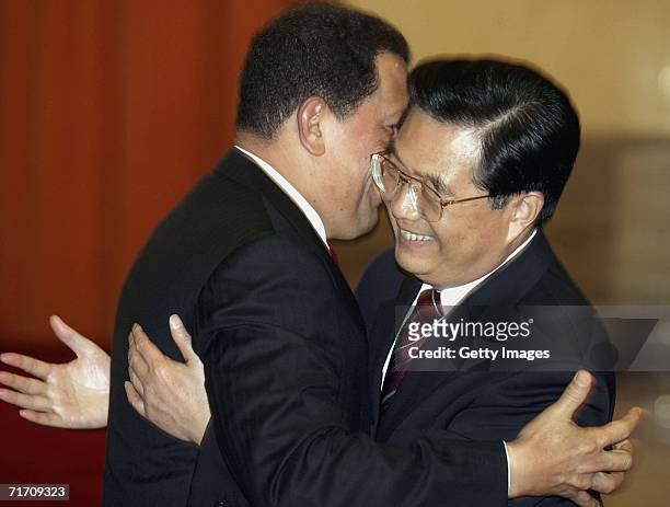 Venezuelan President Hugo Chavez hugs Chinese President Hu Jintao before a welcoming ceremony at the Great Hall of the People on August 24, 2006 in...