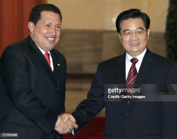 Venezuelan President Hugo Chavez shakes hands with Chinese President Hu Jintao before a welcoming ceremony at the Great Hall of the People on August...