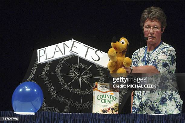Prague, CZECH REPUBLIC: Jocelyne Bell-Burnell, astronomer from Cambridge University, displays a stuffed toy representing planet Pluto during the vote...