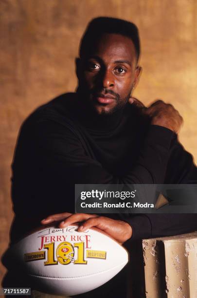 Wide receiver Jerry Rice of the San Francisco 49ers posing with football showing his 101 touchdown receptions to break the all-time record previously...