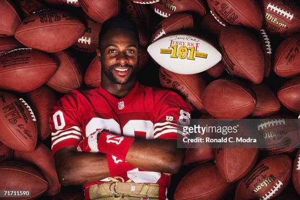 Wide receiver Jerry Rice of the San Francisco 49ers posing with football showing his 101 touchdown receptions to break the all-time record previously...