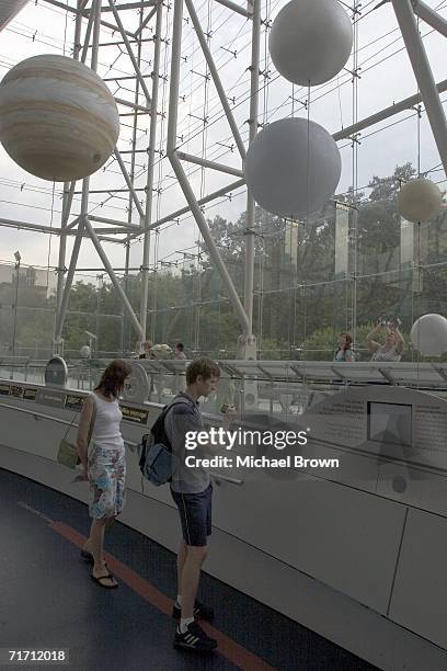 Visitors walk around the American Museum of Natural History?s Cullman Hall of the Universe August 24, 2006 in New York City. After a heated debate...