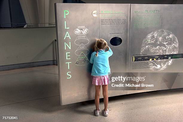 Visitors walk around the American Museum of Natural History?s Cullman Hall of the Universe August 24, 2006 in New York City. After a heated debate...