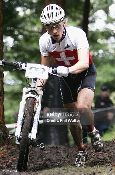 Nino Schurter of Switzerland pushes his bike through the mud during the Men's Under 23 Cross Country competition on the slopes of Mount Ngongotaha on...