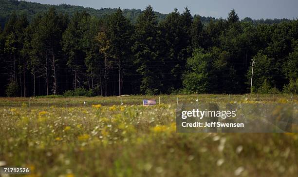 Flag is attached to the fence that closes off the Flight 93 crash site, which is closed to visitors who may view it from the memorial site, August...