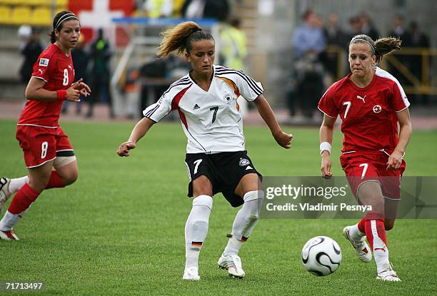 Fatmire Bajramj of Germany tackles Vanessa Buerki and Vanessa Bernauer of Switzerland during the FIFA Women's Under 20 World Championships Group C...