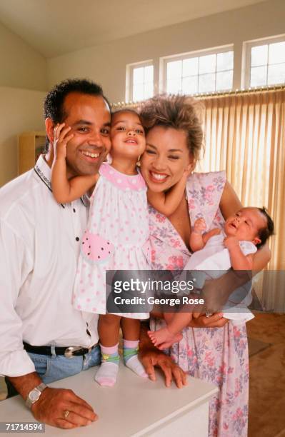 Former Miss USA, singer and actress, Vanessa Williams poses with her now ex-husband Ramon Hervey and their two children Melanie and Jillian, in a...