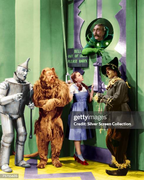 Jack Haley as the Tin Man, Bert Lahr as the Cowardly Lion, Judy Garland as Dorothy, Ray Bolger as the Scarecrow and Frank Morgan as the Doorman to...