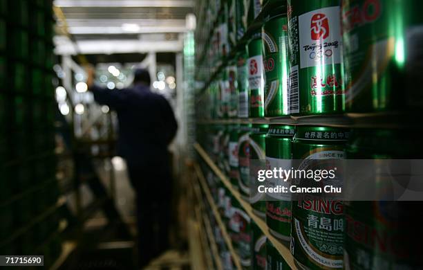 Chinese man works at the storehouse of the Tsingtao beer factory on August 25, 2006 in Qingdao, Shandong Province of China. Tsingtao Beer Group,...