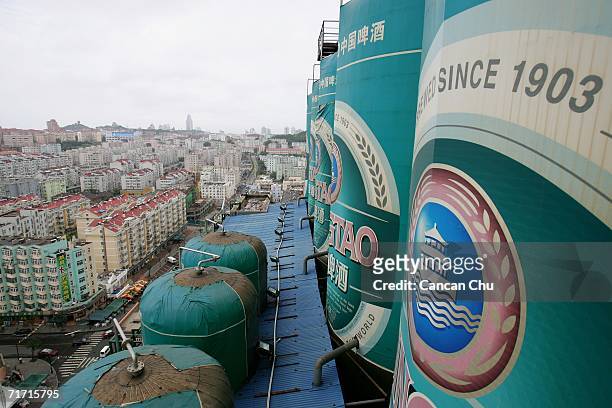 Tanks decorated as Tsingtao Beer cans are displayed on the top of a building at the Tsingtao beer factory on August 25, 2006 in Qingdao, Shandong...