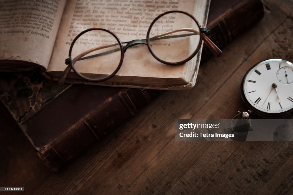 Antique book, watch and eyeglasses