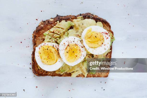 toasted bread with avocado and hard boiled egg - avocado toast stock pictures, royalty-free photos & images
