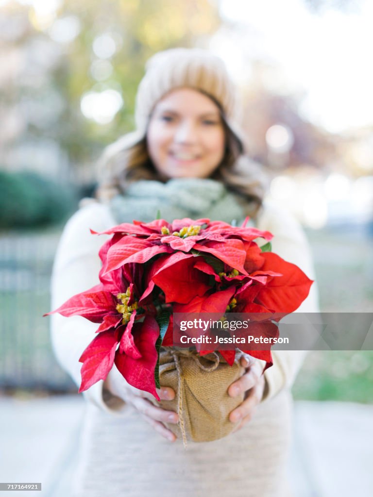 Woman holding poinsettia