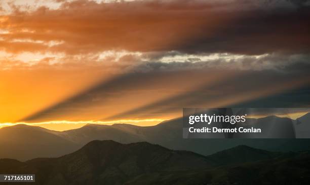 usa, colorado, denver, setting sun shining through clouds over front range - denver sunset stock pictures, royalty-free photos & images