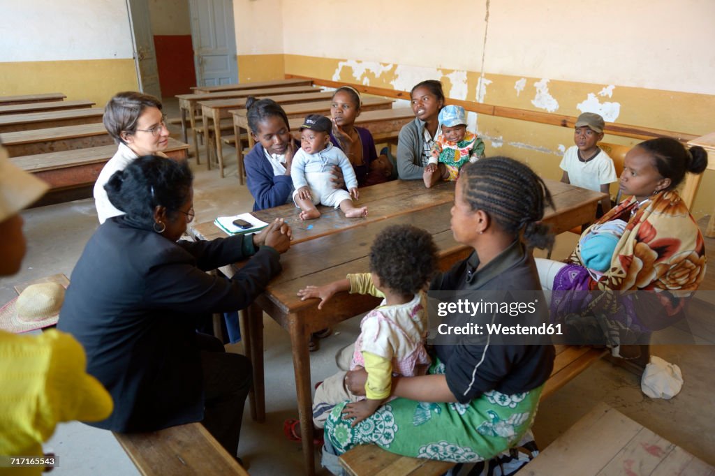 Madagascar, Fianarantsoa, Young mothers and their babies in mother and child group