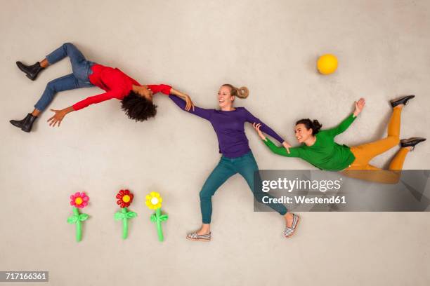 woman spinning friends in nature, having fun - innocenza foto e immagini stock
