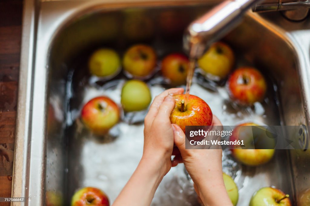 Washing apples in sink