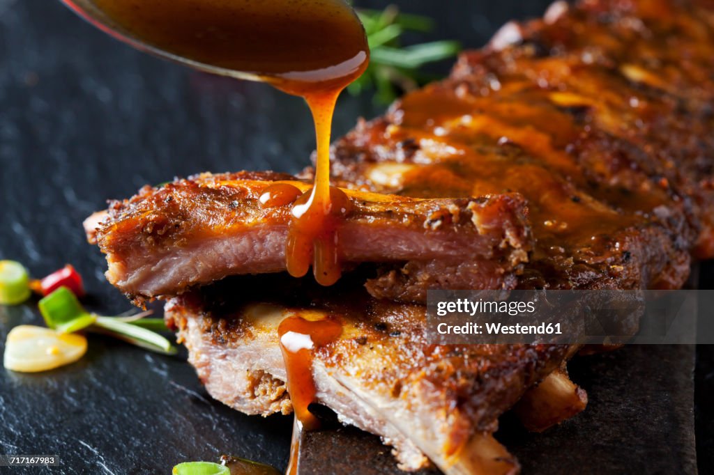 Barbecue sauce dripping on marinated and grilled spare ribs