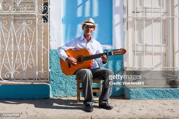 cuba, trinidad, portrait of man playing guitar on the street - caribbean musical instrument stock pictures, royalty-free photos & images