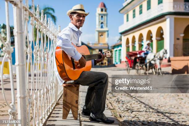 cuba, trinidad, man playing guitar on the street - cuba fotografías e imágenes de stock
