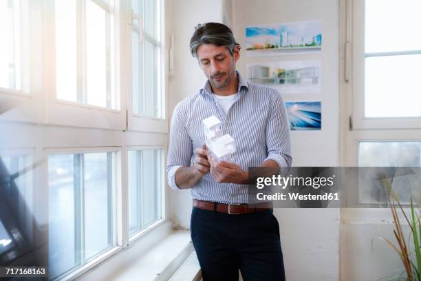 man in office looking at architectural model - shirt mockup stock pictures, royalty-free photos & images