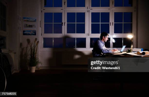 man working late in office - architects of light stock pictures, royalty-free photos & images