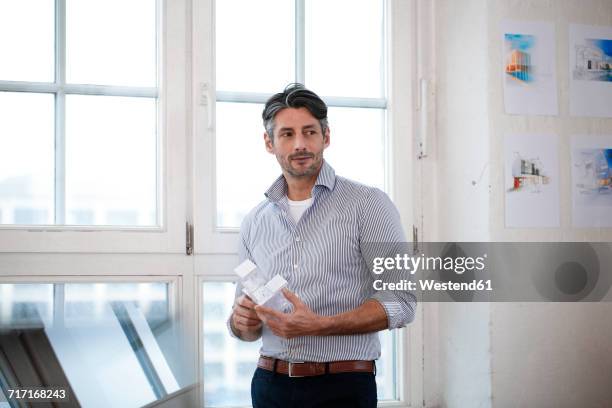 man in office holding architectural model - shirt mockup stock pictures, royalty-free photos & images