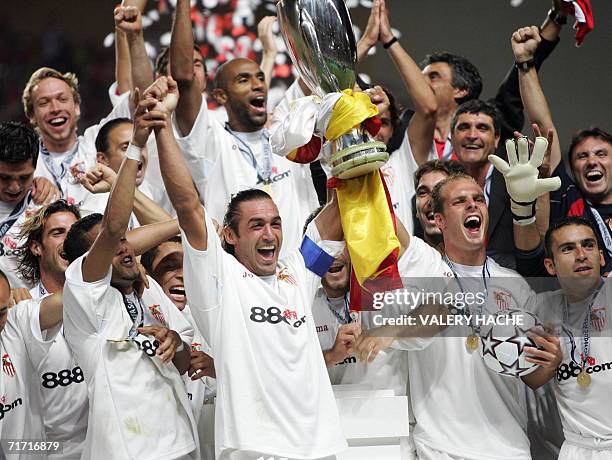 Sevilla's football players jubilate as they hold the trophy of the European Super Cup after the match Barcelona vs. Sevilla, 25 August 2006 at the...