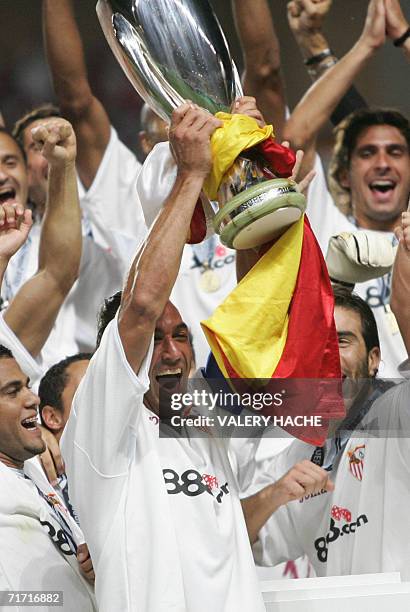 Sevilla's football players jubilate as they hold the trophy of the European Super Cup after the match Barcelona vs. Sevilla, 25 August 2006 at the...