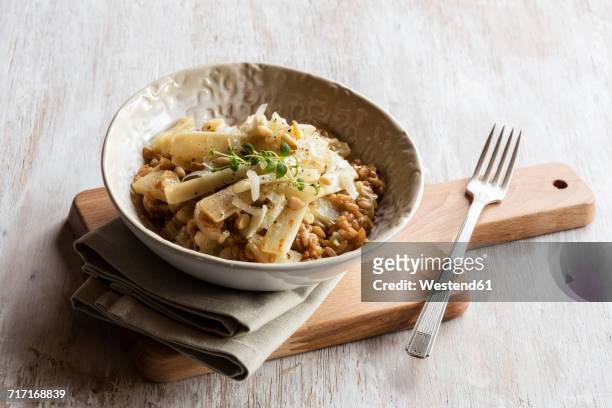 spelt risotto with salsifies, pine nuts and parmesan - salsify fotografías e imágenes de stock