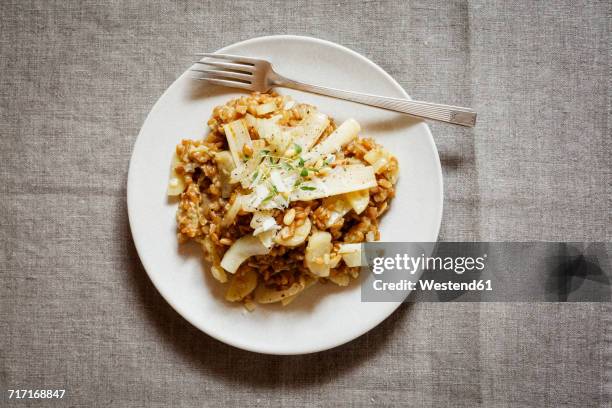spelt risotto with salsifies, pine nuts and parmesan - salsify stock pictures, royalty-free photos & images