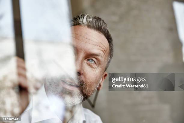 businessman drawing on glass pane - glass business man stock pictures, royalty-free photos & images