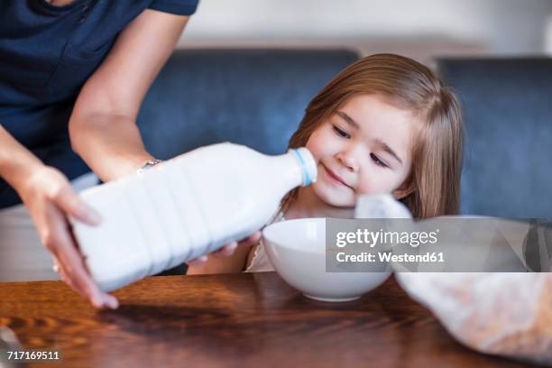 mother preparing breakfast for her daughter - milk family stock pictures, royalty-free photos & images