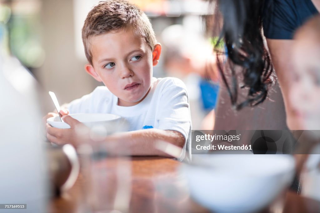 Boy eating breakfast at table