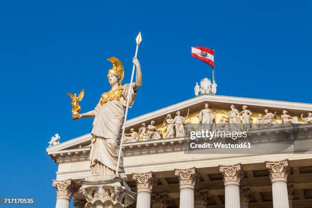 austria, vienna, parliament, statue pallas athene, austrian flag - österreichische flagge stock-fotos und bilder