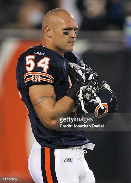 Brian Urlacher of the Chicago Bears watches warm-ups before a game against the Arizona Cardinals on August 25, 2006 at Soldier Field in Chicago,...