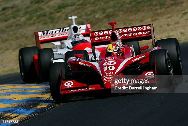 Dan Wheldon drives the Target Ganassi Racing Dallara Honda ahead of Sam Hornish Jr. Driving the Marlboro Team Penske Dallara Honda during practice...