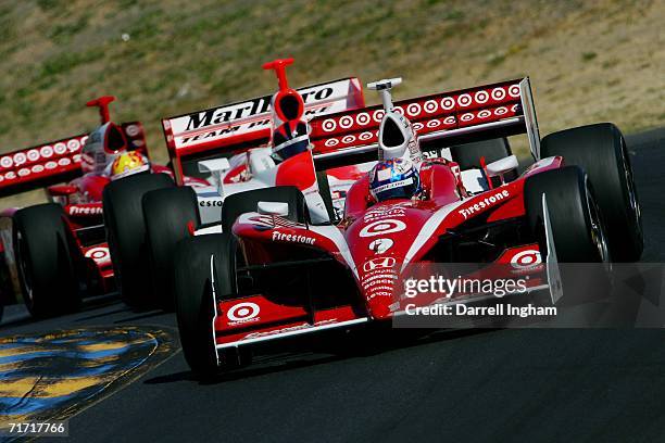 Scott Dixon drives the Target Ganassi Dallara Honda ahead of Helio Castroneves in the Marlboro Team Penske Dallara Honda and Dan Wheldon in the...