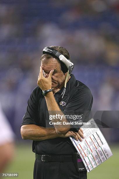 Brian Billick head coach of the Baltimore Ravens reacts to the score against the Minnesota Vikings on August 25, 2006 at the H.H.H. Metrodome in...