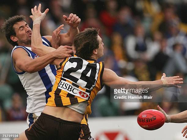 Nathan Thompson for the Kangaroos contests the ball with Trent Croad for Hawthorn during the round 21 AFL match between the Hawthorn Hawks and the...