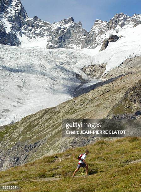 Chamonix-Mont-Blanc, FRANCE: Athlete climbs the col Ferret ont the Mont Blanc during the "North Face Ultra-Trail" , a 158 kilometers-long run around...