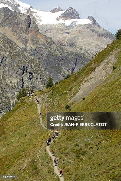 Chamonix-Mont-Blanc, FRANCE: Athetes climb the col Ferret on the du Mont-Blanc during the "North Face Ultra-Trail" , a 158 kilometers-long run around...