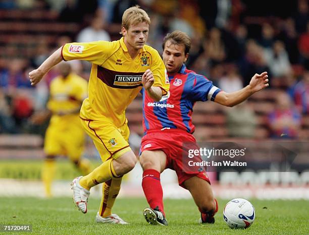 Carl Fletcher of Crystal Palace tries to tackle Alan Mahon of Burnley during the Coca-Cola Championship match between Crystal Palace and Burnley at...