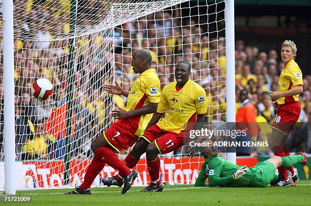 Watford, UNITED KINGDOM: Manchester United's goalkeeper Edwin van de Sar lies stranded as Watford's Damien Francis and Danny Shittu chase down the...