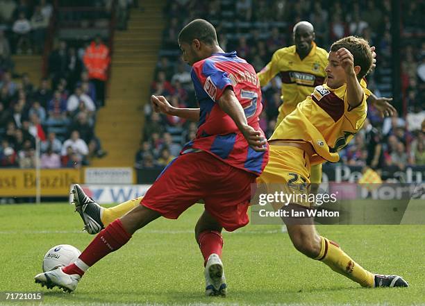 Stephen Foster of Burnley tries to tackle Jobi McAnuff of Crystal Palace during the Coca-Cola Championship match between Crystal Palace and Burnley...