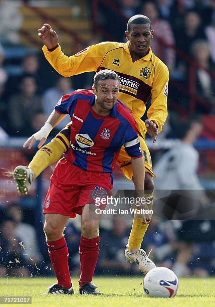 Wade Elliott of Burnley tries to tackle Michael Hughes of Crystal Palace during the Coca-Cola Championship match between Crystal Palace and Burnley...