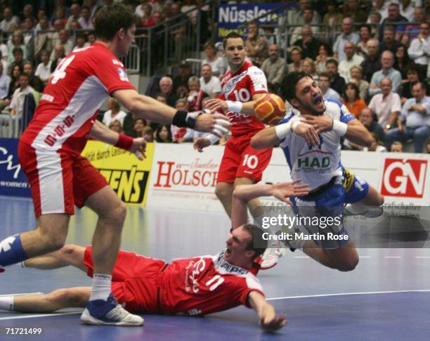 Daniel Kubes and Holger Glandorf of Nordhorn attacks Bertrand Gille of Hamburg during the Handball Bundesliga game between HSG Nordhorn and HSV...