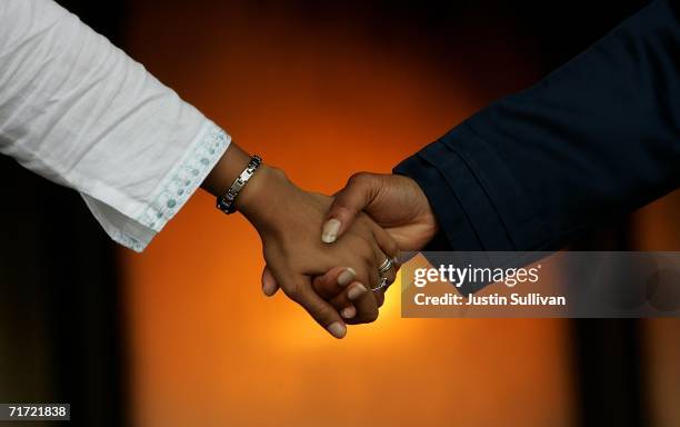 People hold hands as the create a human chain to circle the Louisiana Superdome August 26, 2006 in New Orleans, Louisiana. People held hands and...